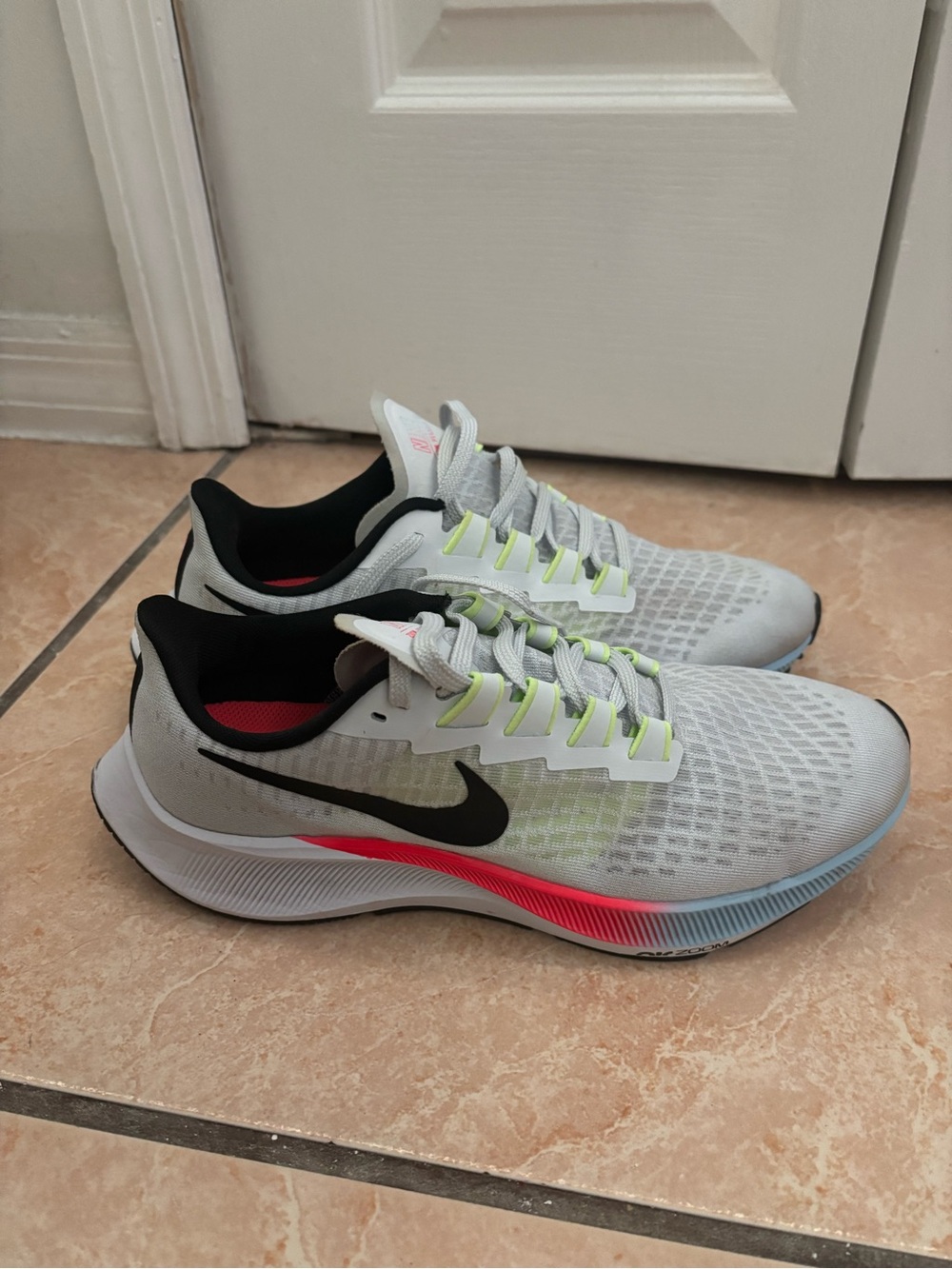 Nike Light Gray Running Shoes with Black Swoosh and Neon Accents